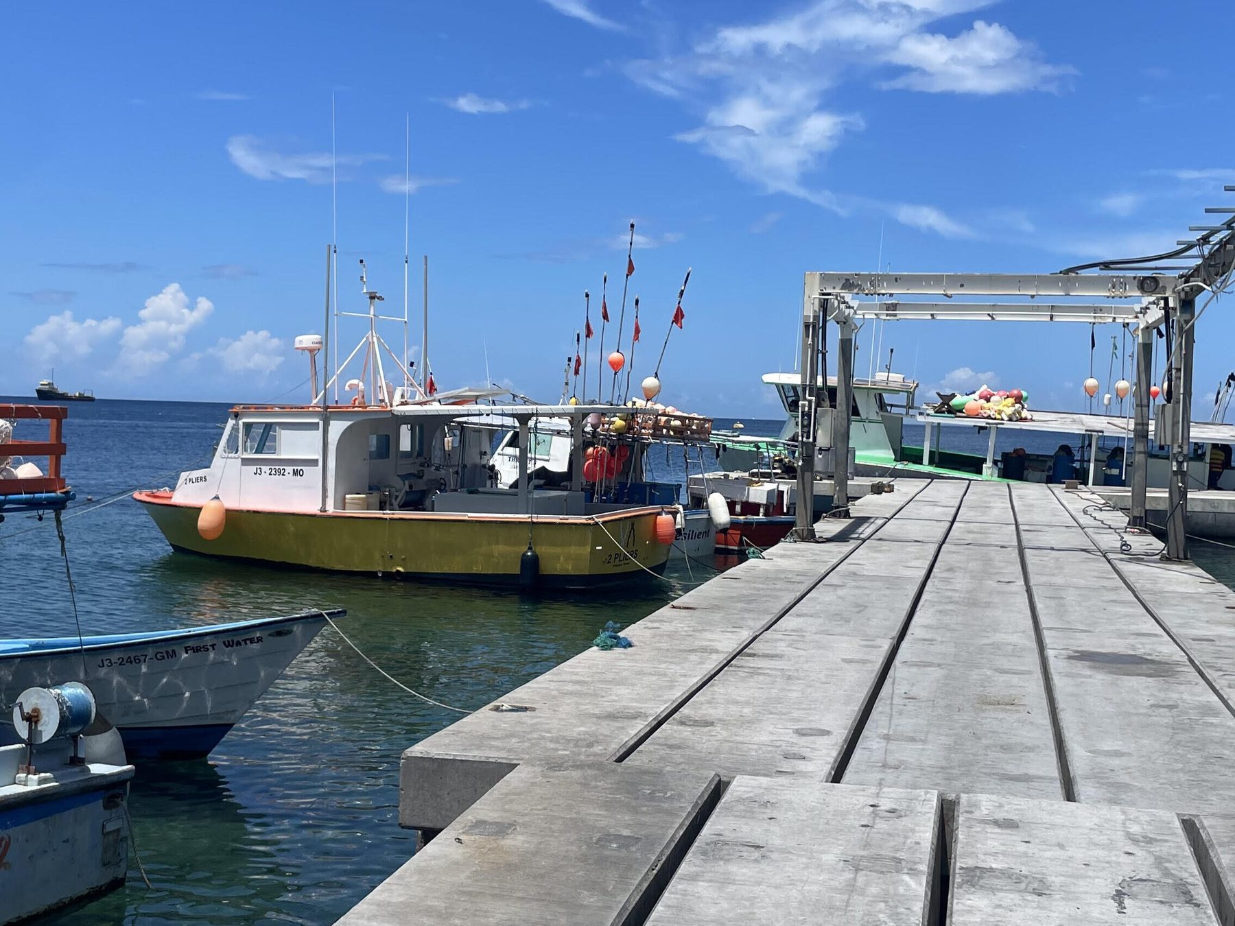 Fishing boats tied up at a wooden dock